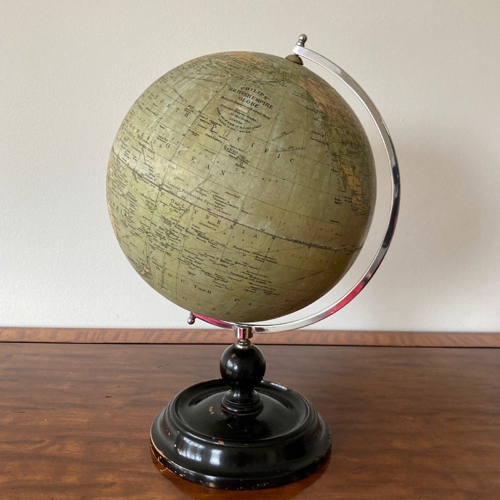 A 1930s Philips British Empire terrestrial desk globe mounted on a chrome semi-meridian and an ebonised wooden base.