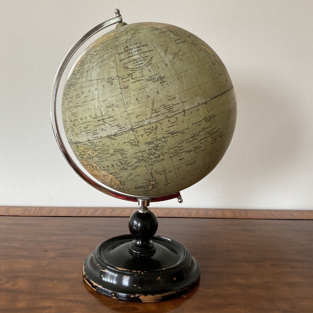 A 1930s Philips British Empire terrestrial desk globe mounted on a chrome semi-meridian and an ebonised wooden base. View V