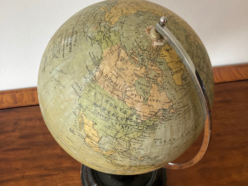 A 1930s Philips British Empire terrestrial desk globe mounted on a chrome semi-meridian and an ebonised wooden base. View VII