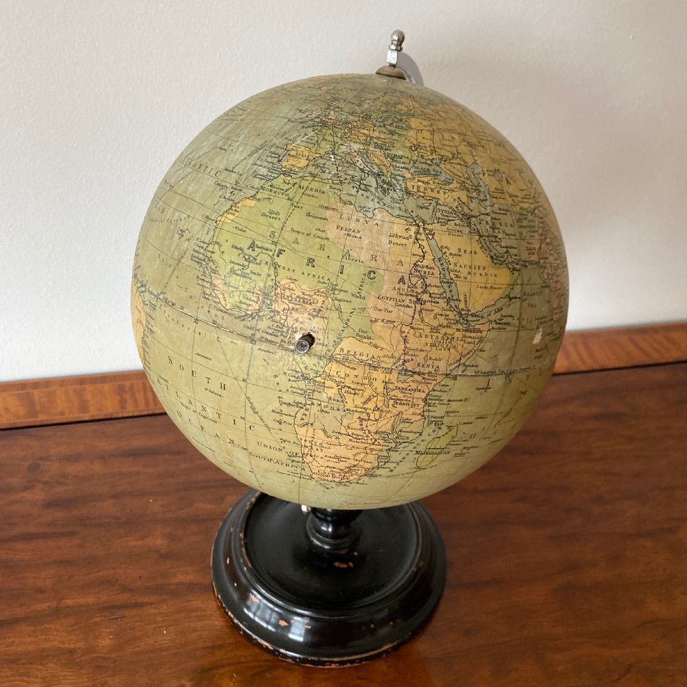A 1930s Philips British Empire terrestrial desk globe mounted on a chrome semi-meridian and an ebonised wooden base. View IX