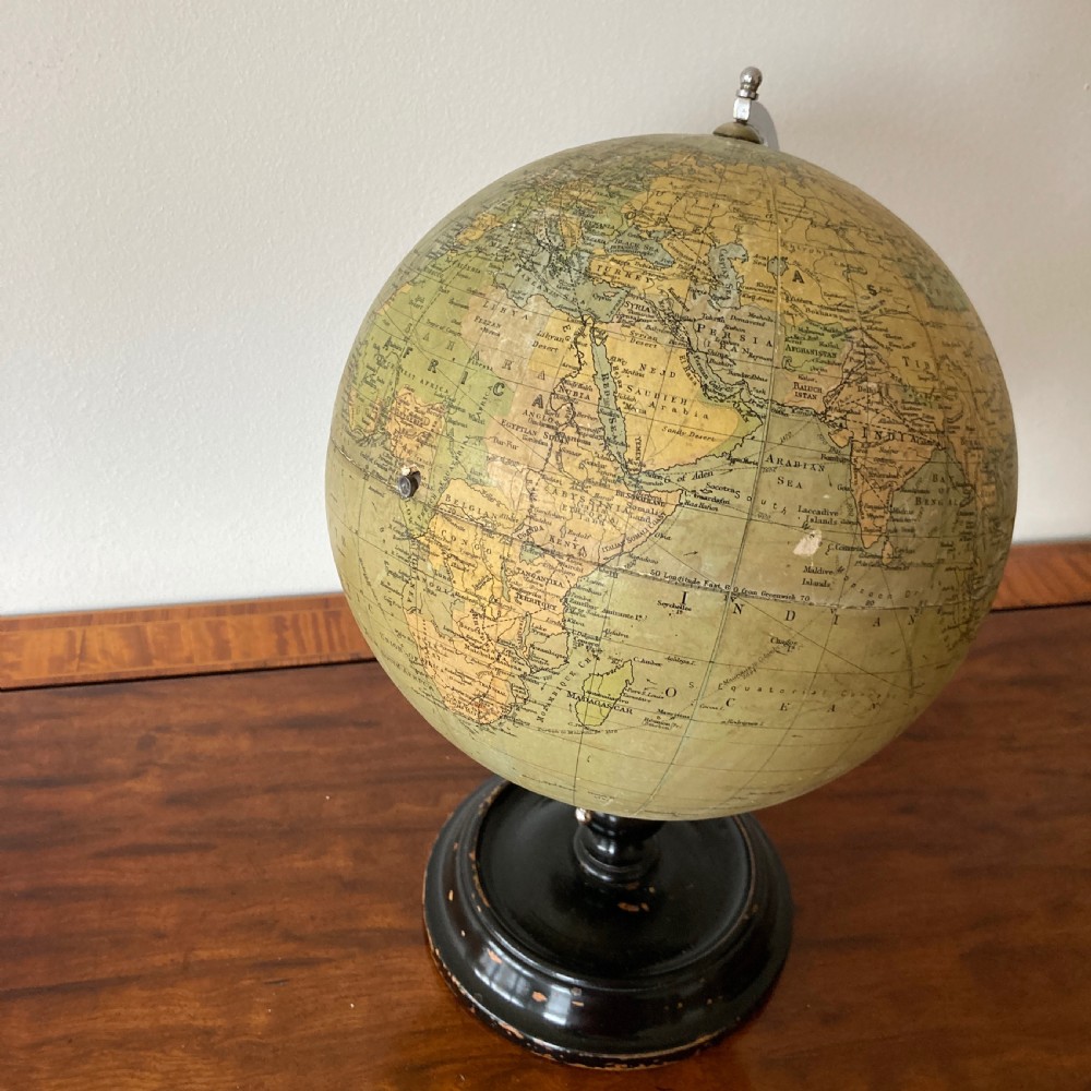 A 1930s Philips British Empire terrestrial desk globe mounted on a chrome semi-meridian and an ebonised wooden base. View X