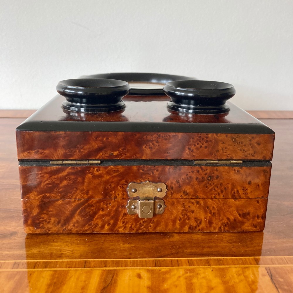 An antique Victorian hinged burr yew wood tabletop stereoscope shown open, featuring dual circular viewing lenses, a central magnifying lens, and a selection of stereoview cards. View X