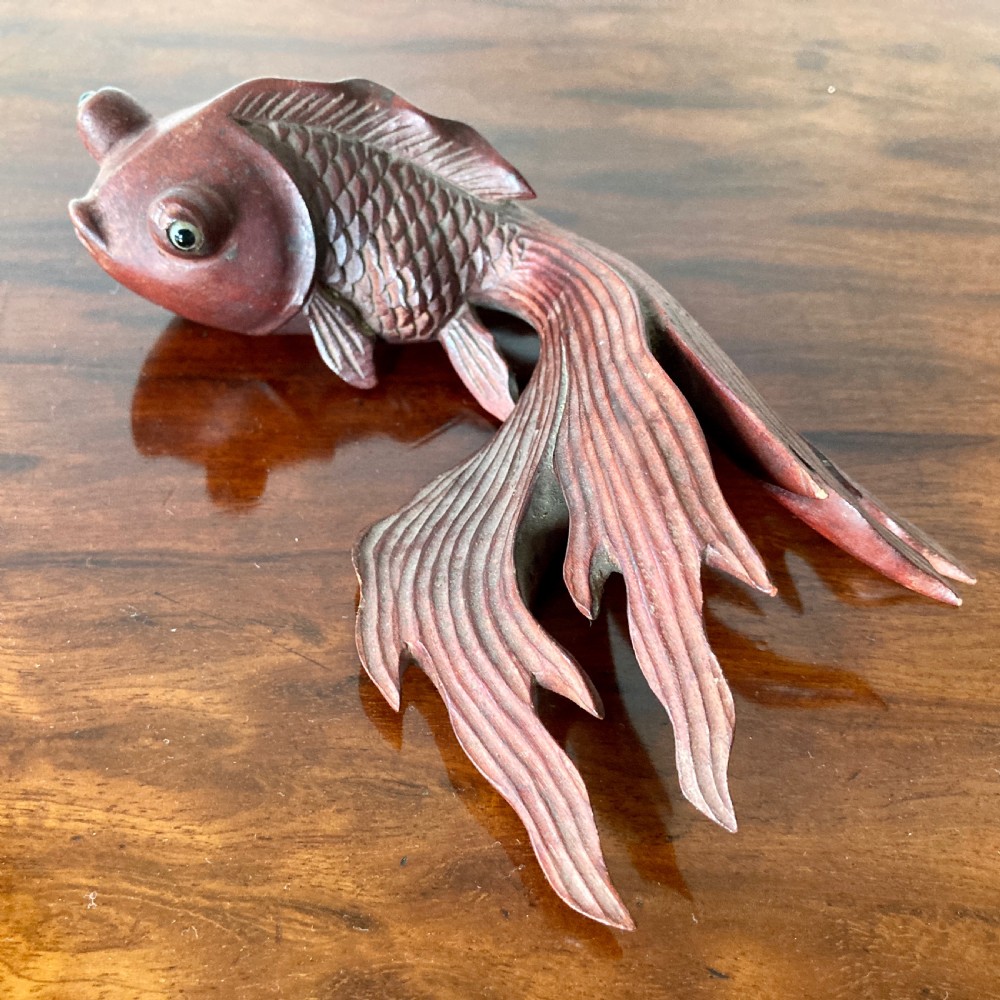 Three 19th-century Oriental carved wooden goldfish figures with detailed scales, flowing fins, and inset glass eyes displayed on a polished surface. View III