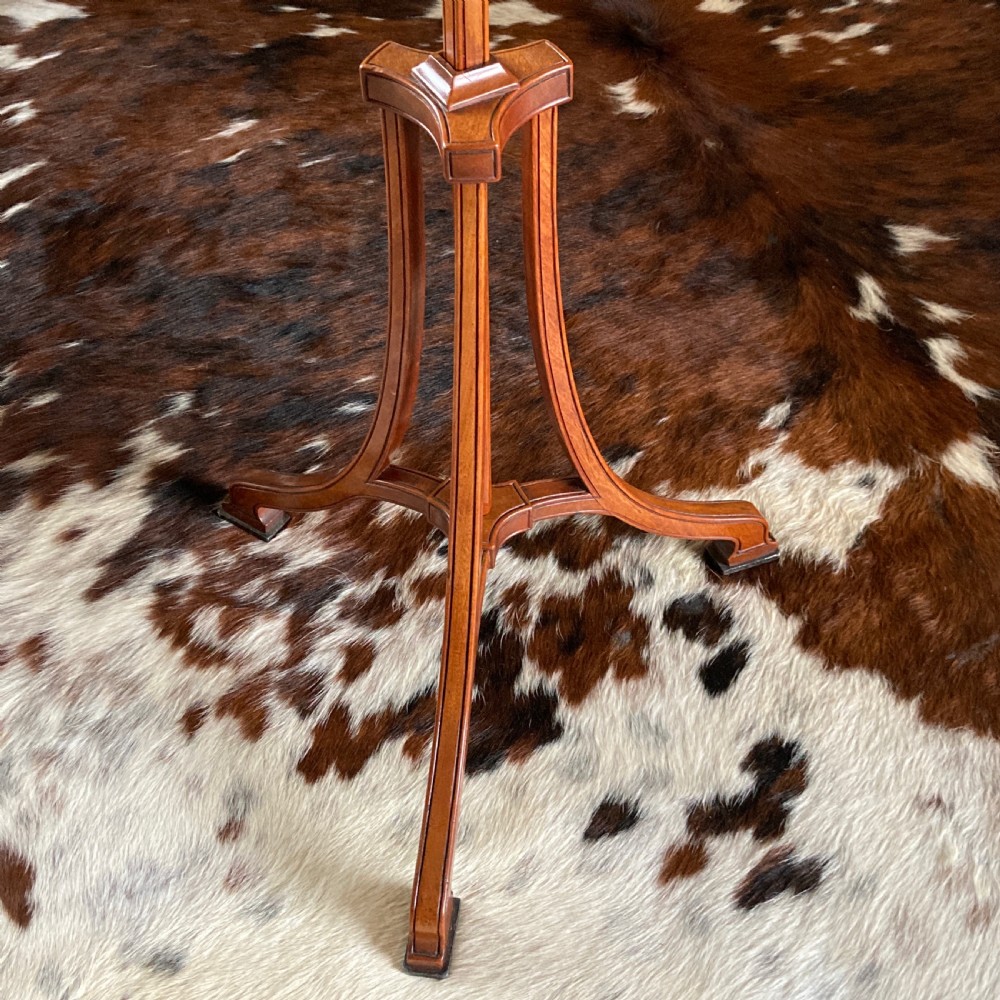 An oval mahogany fire screen containing an 18th-century silk needlework scene of pastoral figures, mounted on a central wooden pole. View X