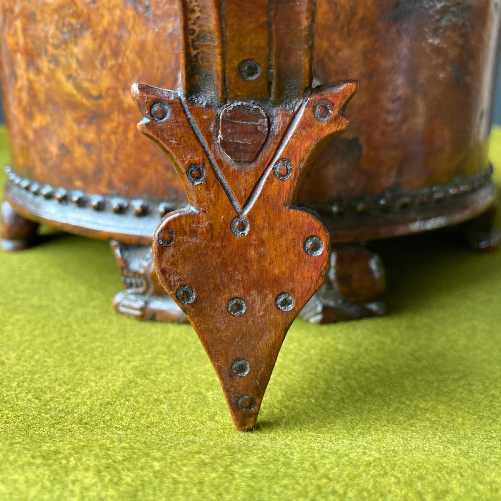 An 18th-century Norwegian carved wooden peg tankard featuring a lion thumbpiece, domed relief-carved lid, and carved lion feet in a warm brown finish. View IX