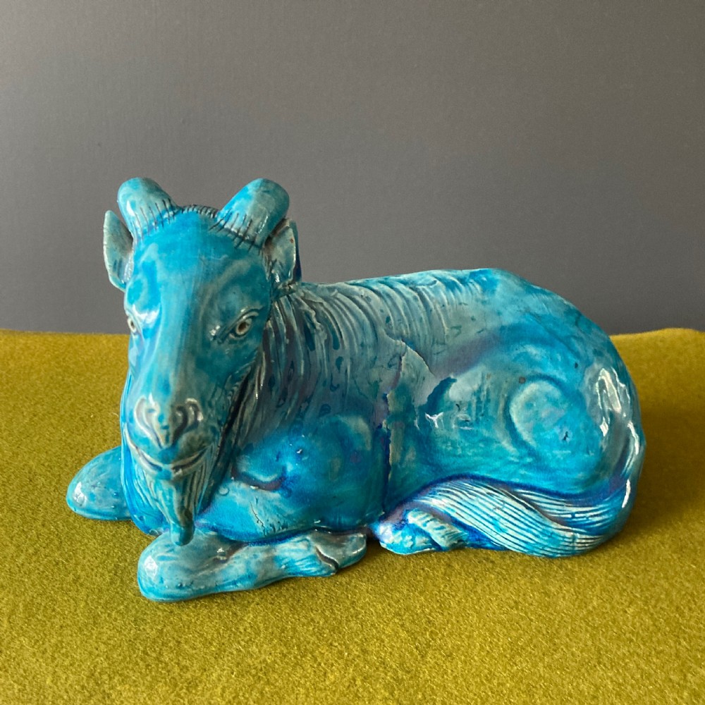 A pair of nineteenth-century Chinese porcelain recumbent goats featuring vibrant turquoise blue monochrome glazing and incised fur detailing. View V