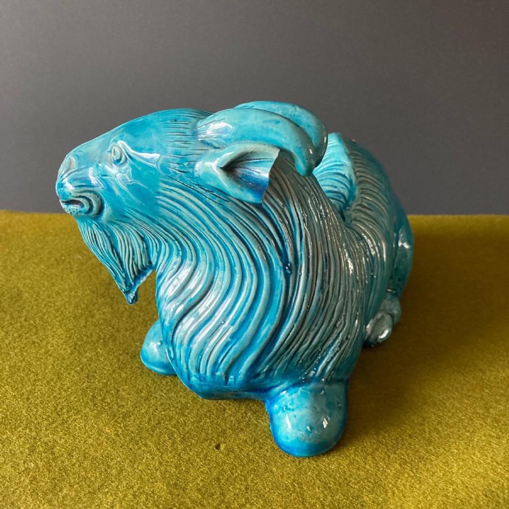 A pair of nineteenth-century Chinese porcelain recumbent goats featuring vibrant turquoise blue monochrome glazing and incised fur detailing. View VI