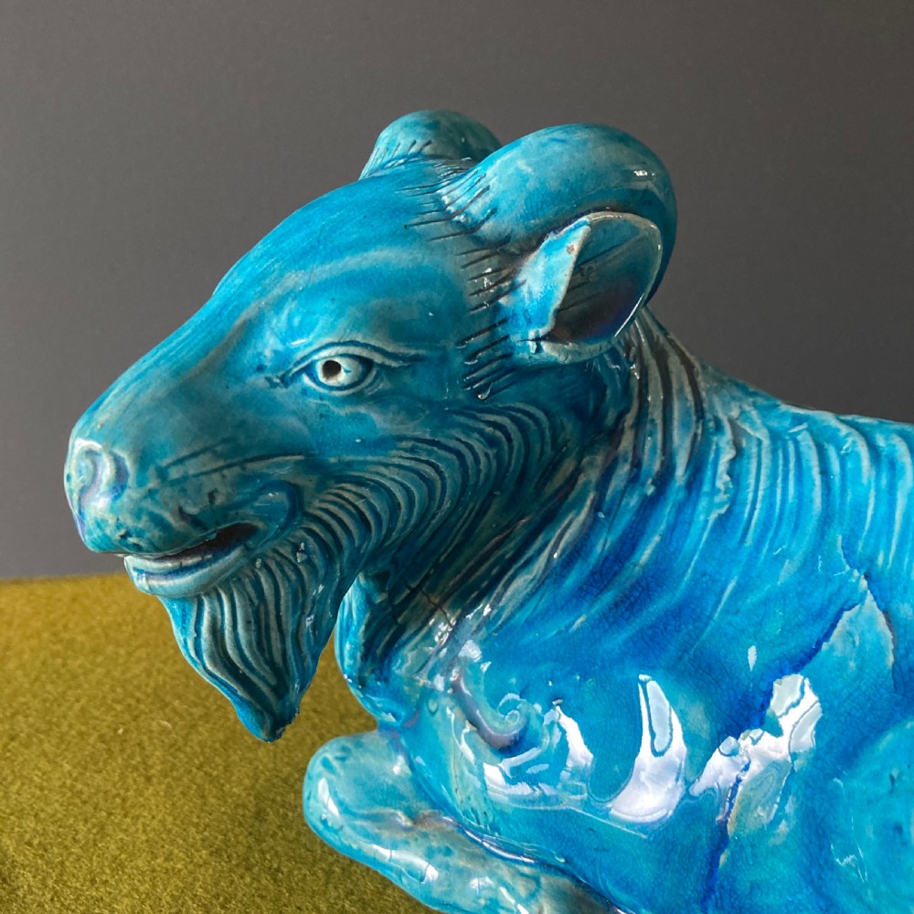 A pair of nineteenth-century Chinese porcelain recumbent goats featuring vibrant turquoise blue monochrome glazing and incised fur detailing. View IX