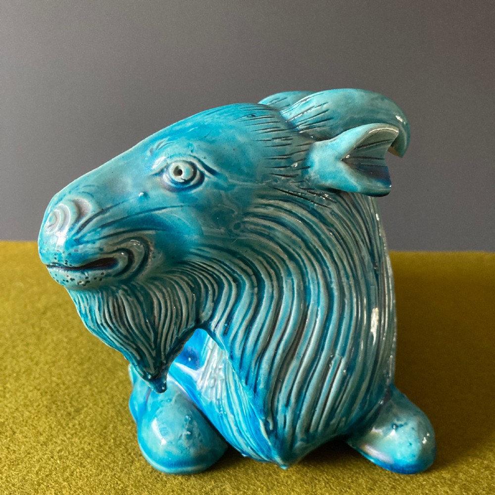 A pair of nineteenth-century Chinese porcelain recumbent goats featuring vibrant turquoise blue monochrome glazing and incised fur detailing. View X