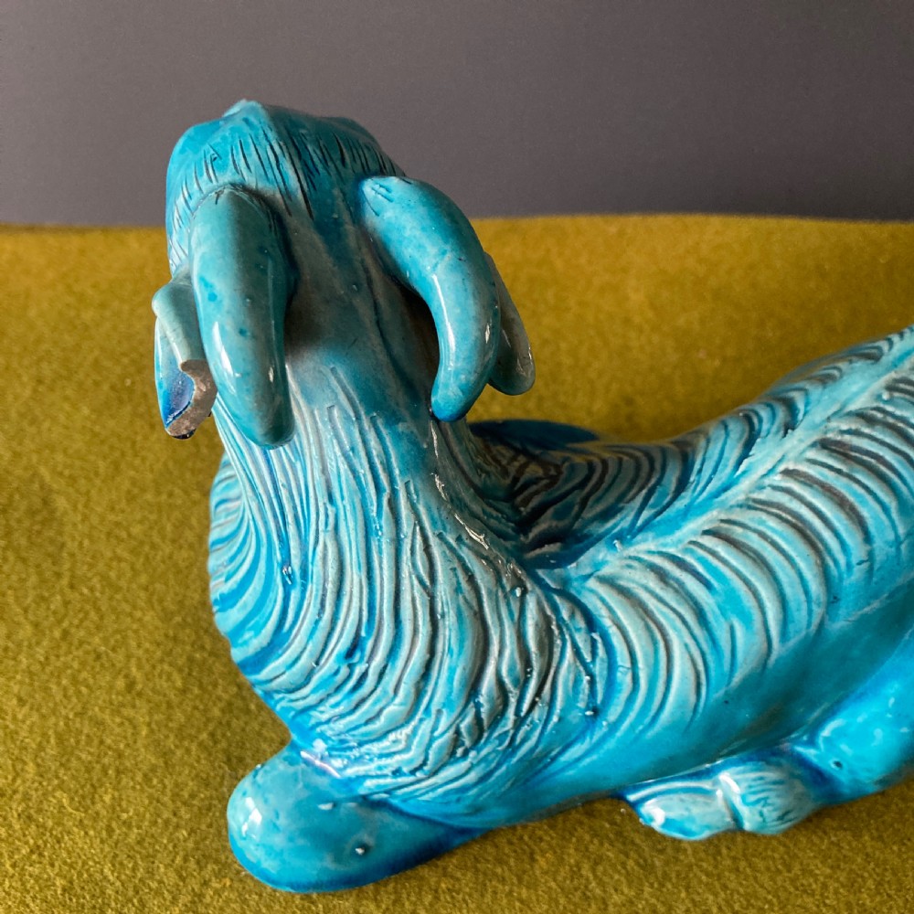A pair of nineteenth-century Chinese porcelain recumbent goats featuring vibrant turquoise blue monochrome glazing and incised fur detailing. View XII
