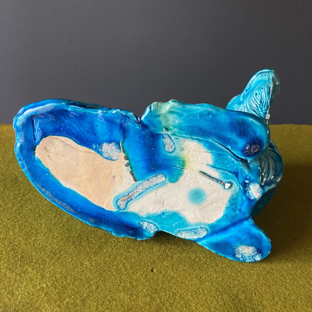A pair of nineteenth-century Chinese porcelain recumbent goats featuring vibrant turquoise blue monochrome glazing and incised fur detailing. View XVI