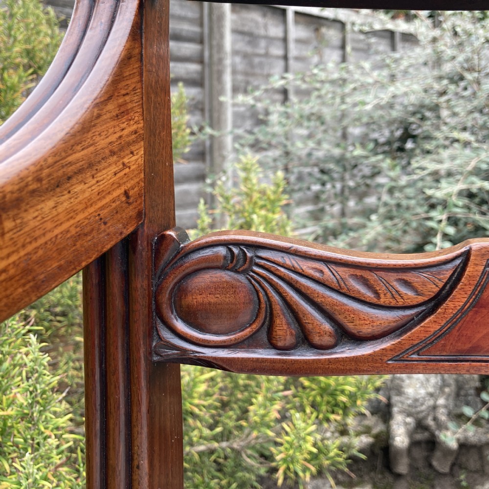 A George III mahogany desk armchair featuring reeded arms, a tablet top rail with flame mahogany veneer, and a patterned upholstered seat. View III