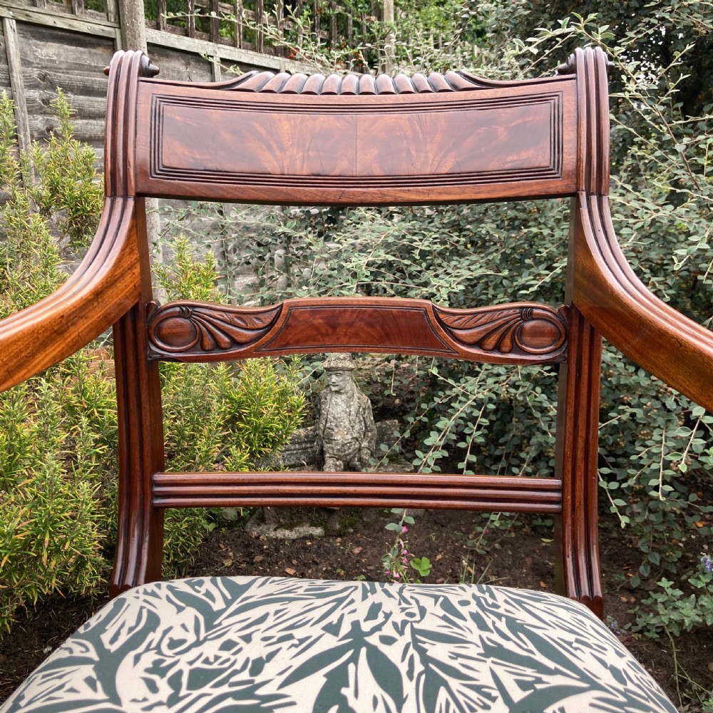 A George III mahogany desk armchair featuring reeded arms, a tablet top rail with flame mahogany veneer, and a patterned upholstered seat. View VI