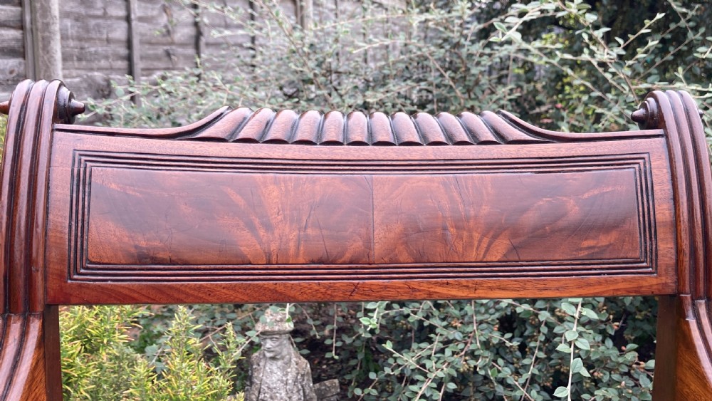 A George III mahogany desk armchair featuring reeded arms, a tablet top rail with flame mahogany veneer, and a patterned upholstered seat. View VIII