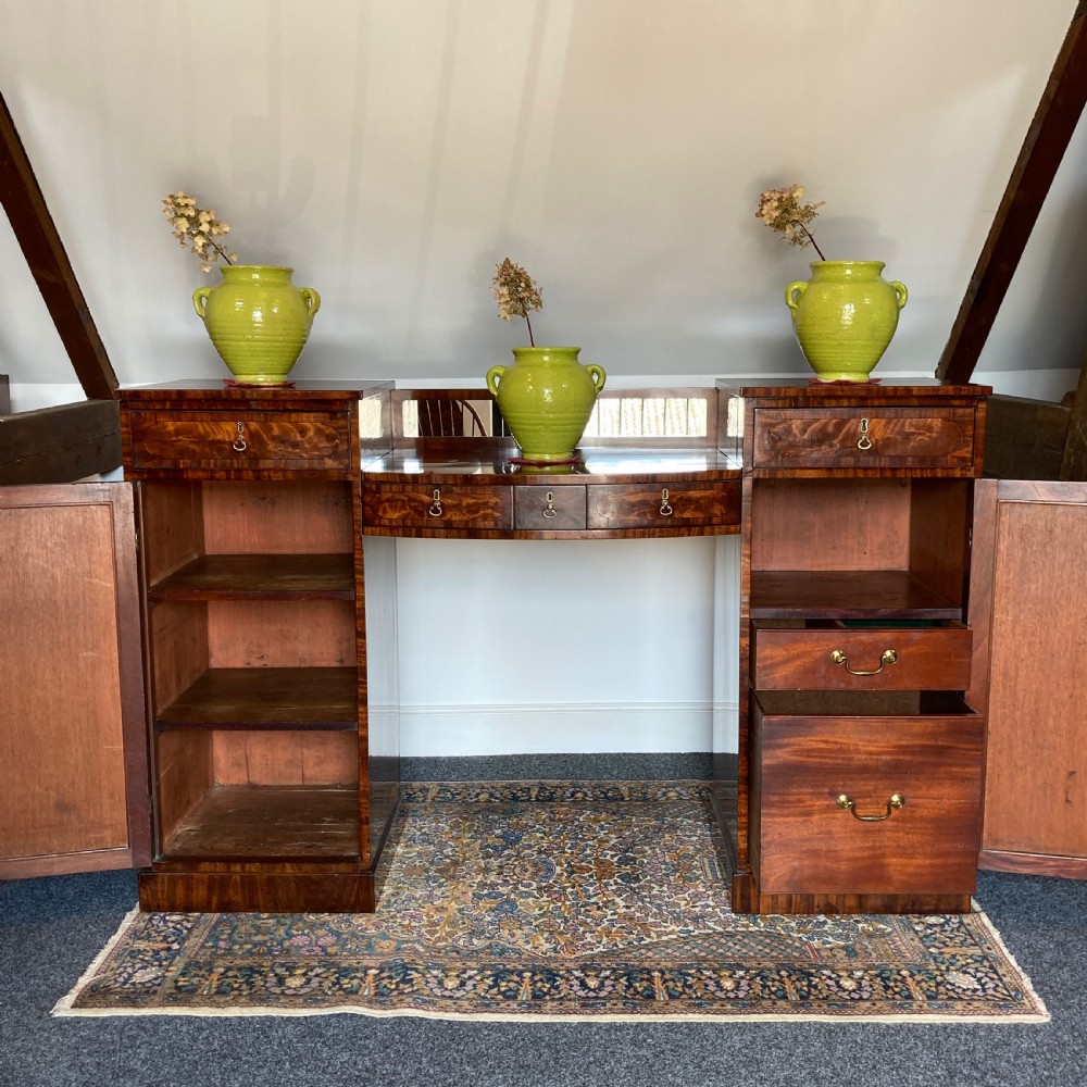 A late Georgian mahogany pedestal sideboard featuring two outer pedestals with floral fabric panels, central drawers, and warm flame mahogany wood grain. View III