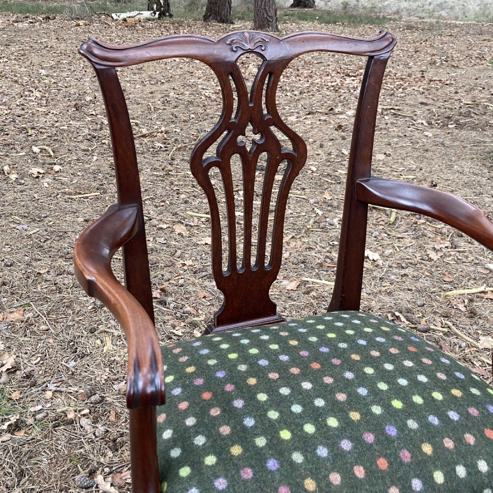 A pair of 1830s mahogany open armchairs featuring carved top rails, pierced splats, swept arms, and seats upholstered in a green patterned fabric. View III