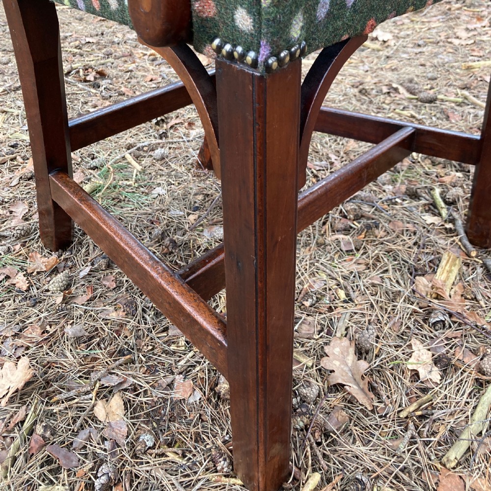 A pair of 1830s mahogany open armchairs featuring carved top rails, pierced splats, swept arms, and seats upholstered in a green patterned fabric. View XI