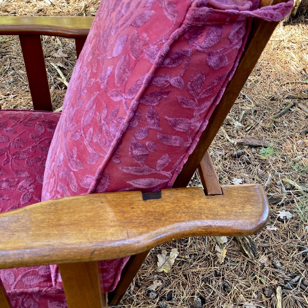 An Edwardian teak reclining armchair featuring slatted side panels, wide flat armrests, and pink floral upholstered cushions. View VIII