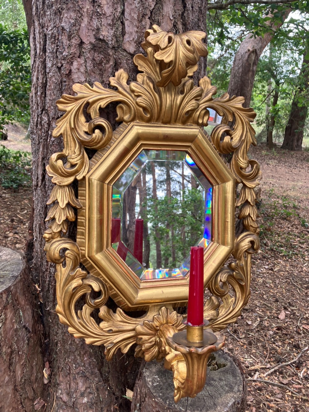An octagonal 19th-century French giltwood girandole wall mirror featuring carved acanthus leaf motifs and an integrated central candle sconce holding a single candle. View II