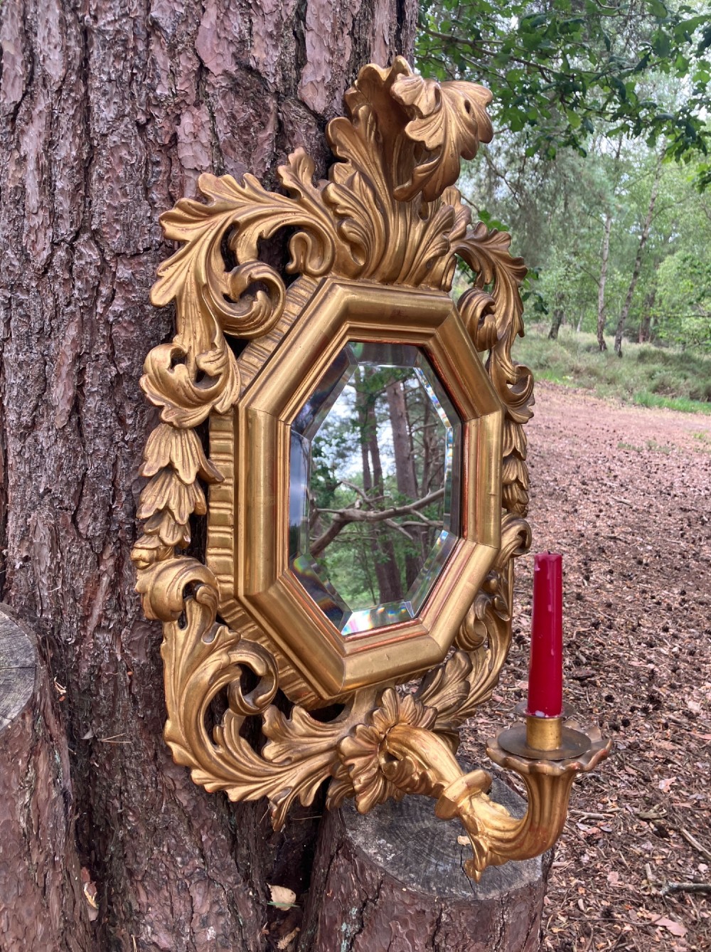 An octagonal 19th-century French giltwood girandole wall mirror featuring carved acanthus leaf motifs and an integrated central candle sconce holding a single candle. View III