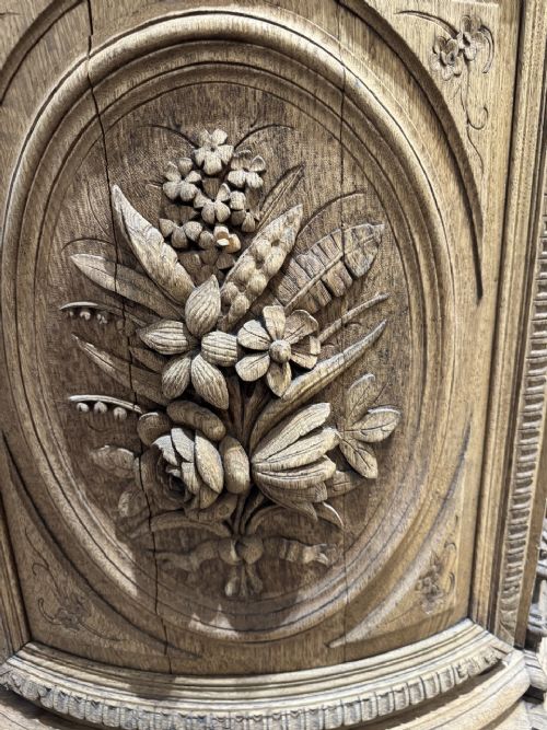 A light oak sideboard with detailed relief carvings of deer in a forest setting on the central panel, flanked by foliage motifs. View VI