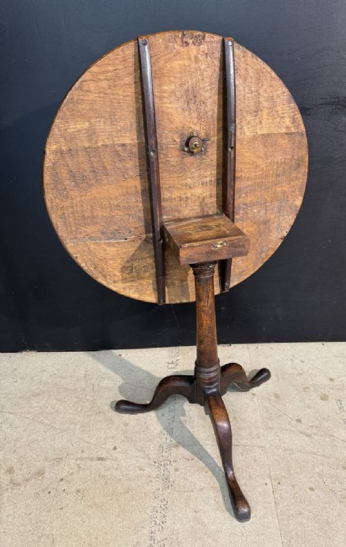 A Georgian solid oak tilt-top table with a circular surface supported by a turned pedestal column and three cabriole tripod legs. View V