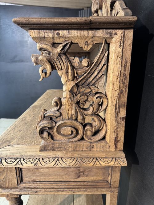 A 19th-century French carved oak buffet featuring an ornate crest, open shelf, turned columns, and carved drawers. View XII