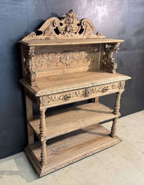 A 19th-century French carved oak buffet featuring an ornate crest, open shelf, turned columns, and carved drawers. View XIV