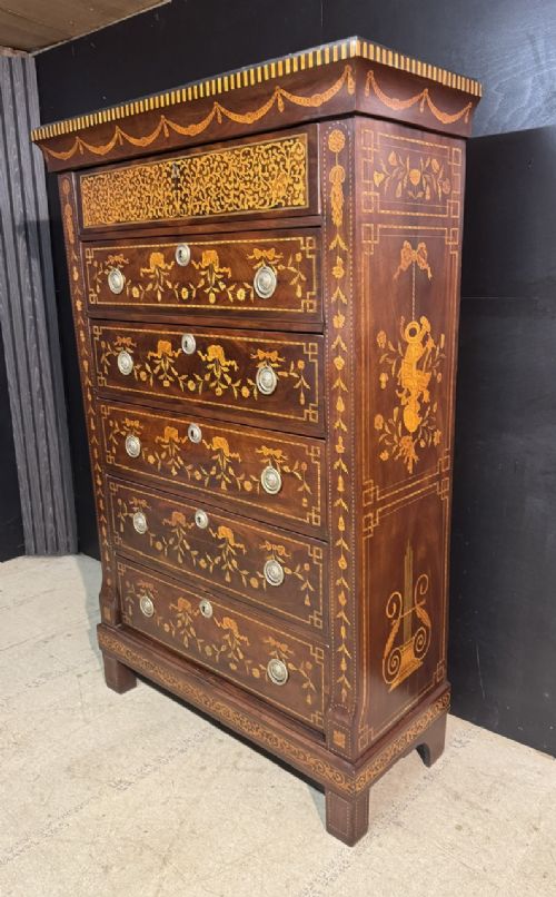 An 18th-century Dutch mahogany tall chest of drawers featuring intricate floral marquetry inlay across six drawers with brass handles. View VI