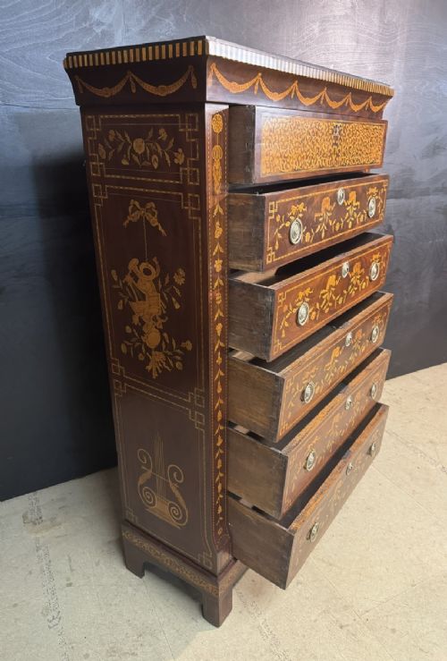 An 18th-century Dutch mahogany tall chest of drawers featuring intricate floral marquetry inlay across six drawers with brass handles. View IX