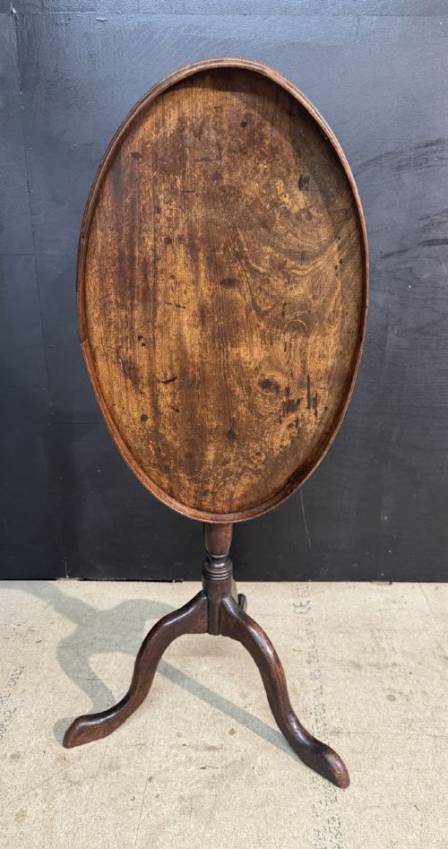 A Georgian mahogany tilt-top table featuring a circular top raised on a turned pedestal column and tripod cabriole legs. View III