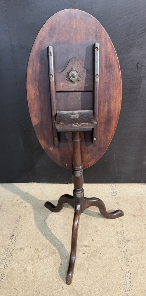 A Georgian mahogany tilt-top table featuring a circular top raised on a turned pedestal column and tripod cabriole legs. View IV