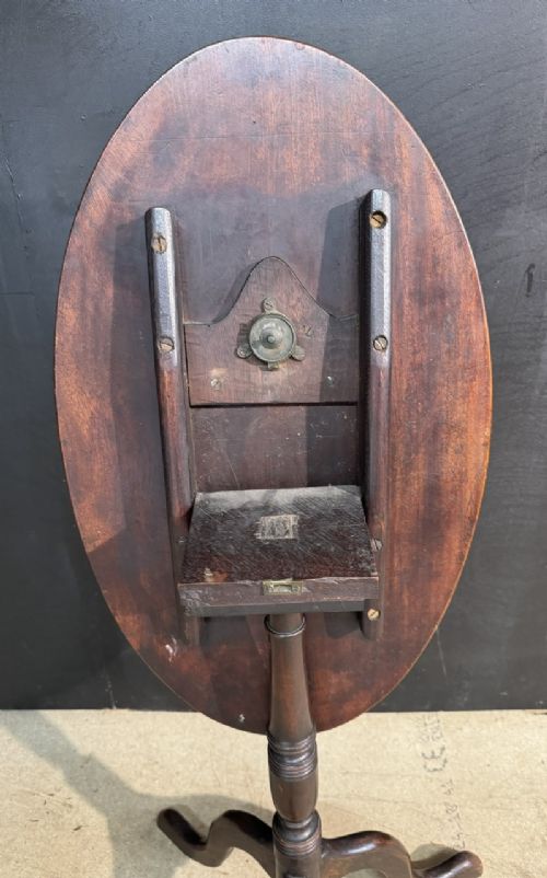 A Georgian mahogany tilt-top table featuring a circular top raised on a turned pedestal column and tripod cabriole legs. View V