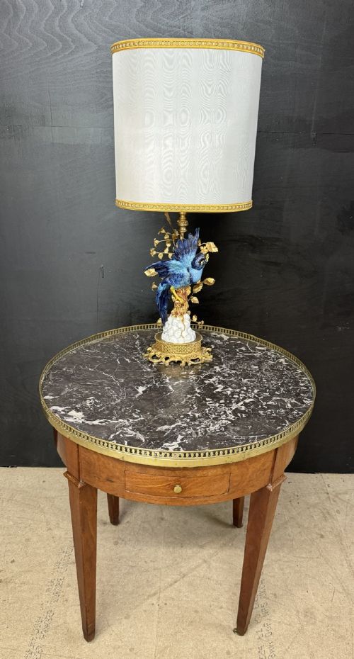 A circular French Louis XVI style lamp table featuring a dark veined marble top, a pierced brass gallery rim, a single drawer, and four square tapered legs. View X