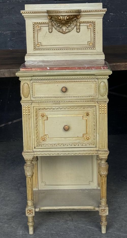 A matching pair of painted French neoclassical bedside cabinets featuring red marble tops, carved bracket superstructures, gold leaf detailing, drawers, and open lower shelves. View XIII