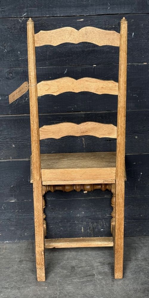 A set of six light oak ladderback dining chairs featuring wavy back slats, turned legs, and solid wooden seats. View VII
