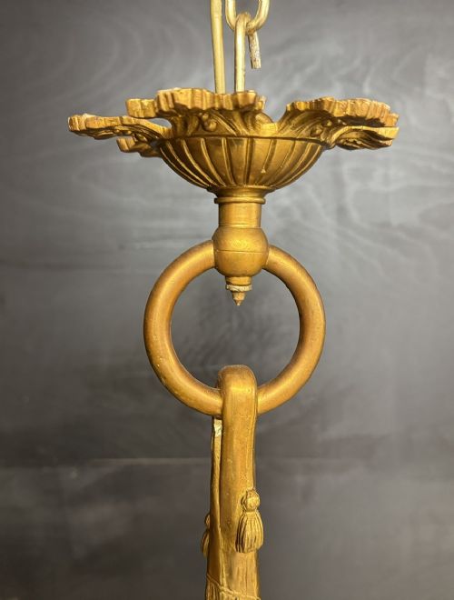 An ornate French gilt bronze chandelier featuring scroll arms, cut glass inserts, and ruffled white glass flower shades. View X