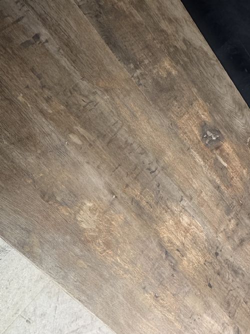 An extra long natural oak refectory dining table featuring a timber plank top supported by twin turned baluster trestle legs connected by a floor-level stretcher. View XIV