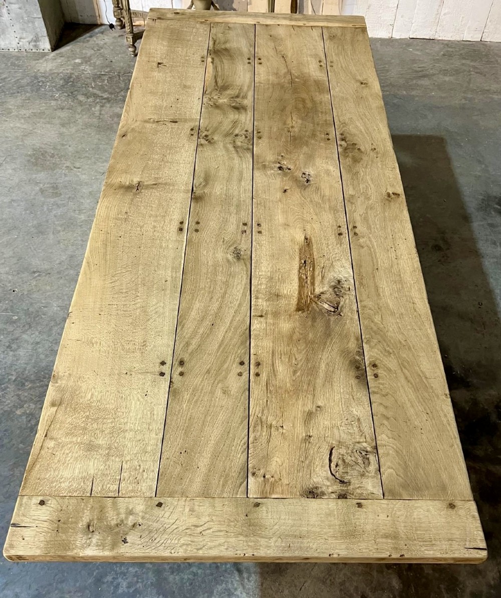 A rectangular bleached oak farmhouse dining table featuring turned baluster legs and a central stretcher base. View III