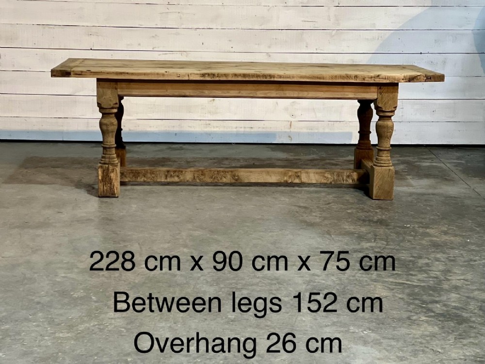 A rectangular bleached oak farmhouse dining table featuring turned baluster legs and a central stretcher base. View IV