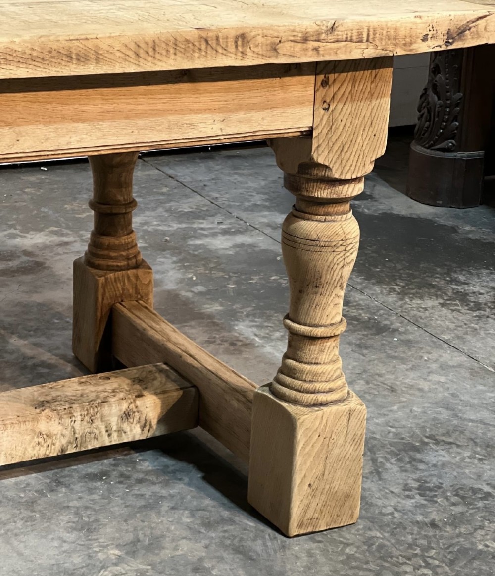 A rectangular bleached oak farmhouse dining table featuring turned baluster legs and a central stretcher base. View VI