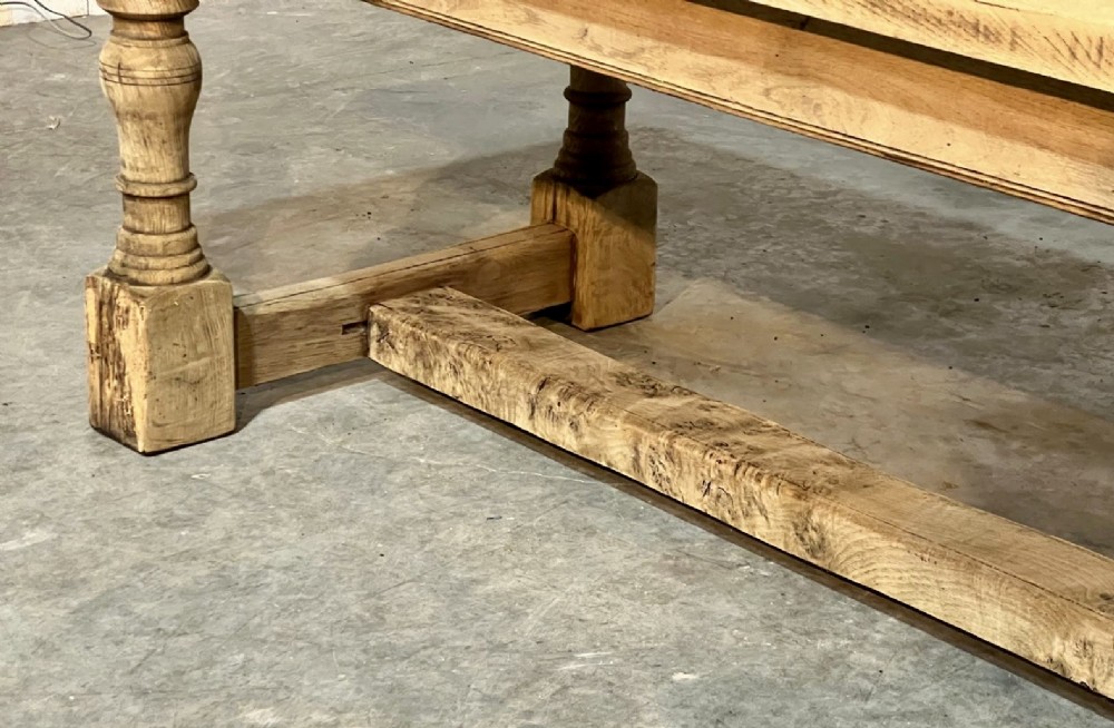 A rectangular bleached oak farmhouse dining table featuring turned baluster legs and a central stretcher base. View VIII