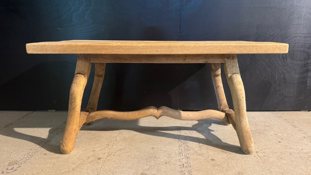 A rectangular low French oak coffee table with curved splayed legs and a contoured central stretcher. View II
