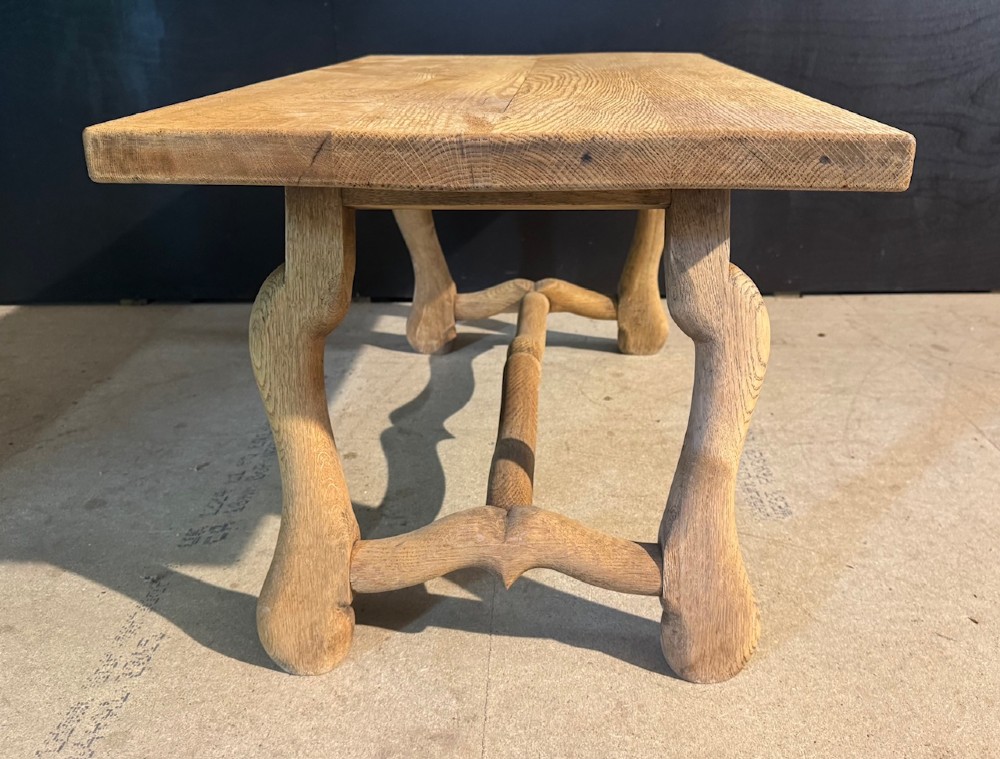 A rectangular low French oak coffee table with curved splayed legs and a contoured central stretcher. View VI