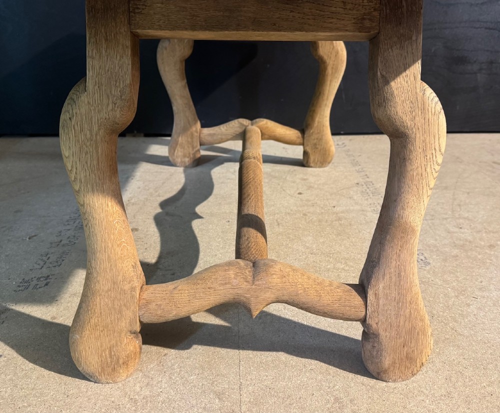 A rectangular low French oak coffee table with curved splayed legs and a contoured central stretcher. View VII