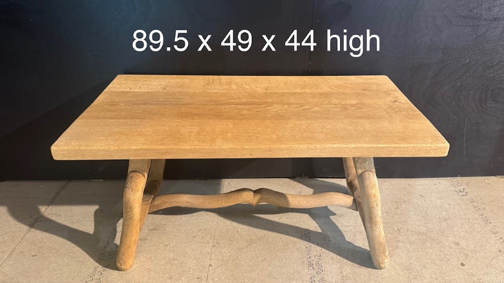 A rectangular low French oak coffee table with curved splayed legs and a contoured central stretcher. View X