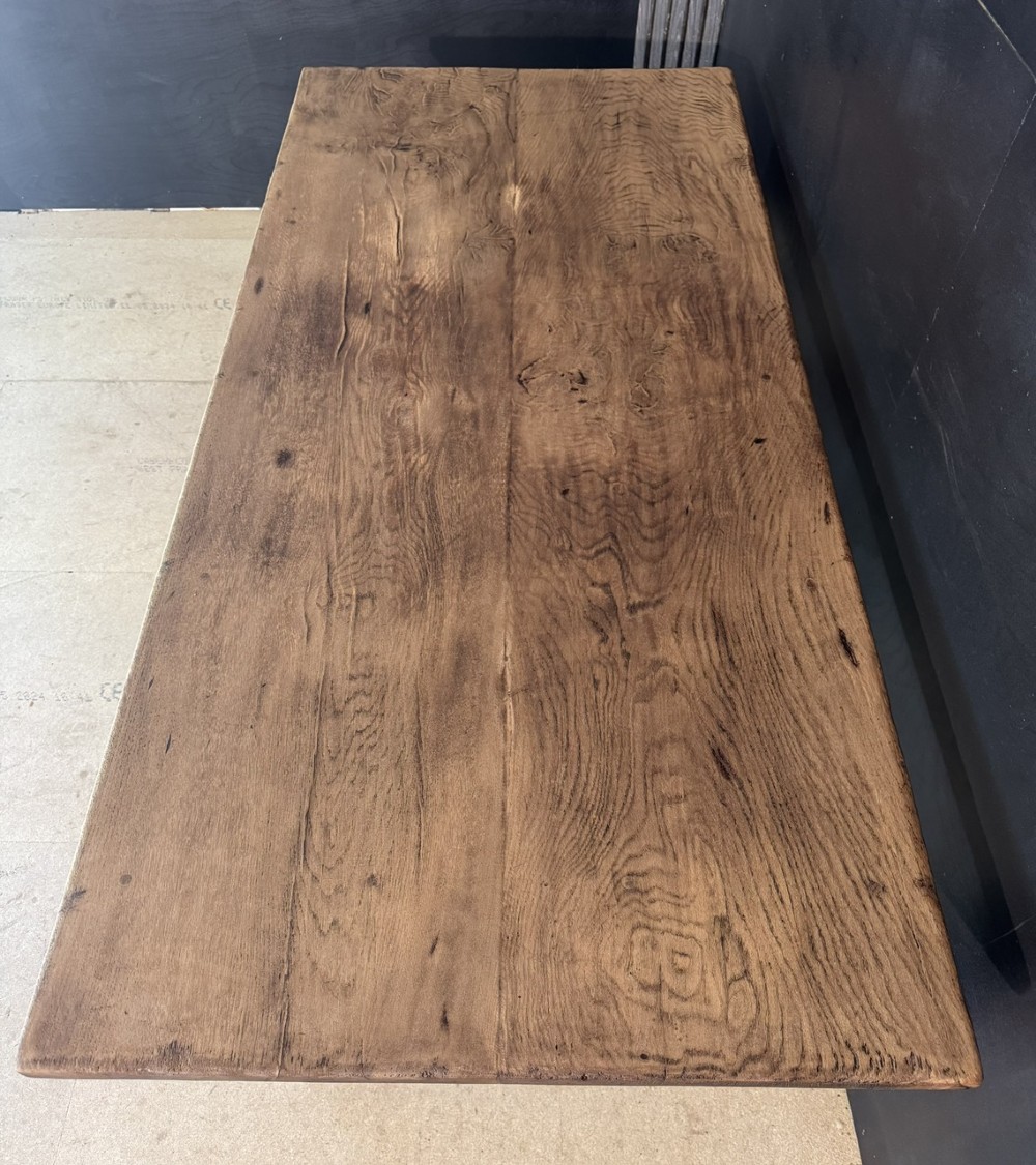 A solid oak farmhouse dining table with a thick plank top, turned baluster legs, and a low central stretcher rail. View IV