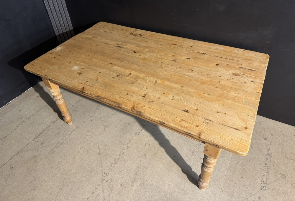 A rectangular pine farmhouse dining table featuring a solid plank top and four turned wooden legs. View II