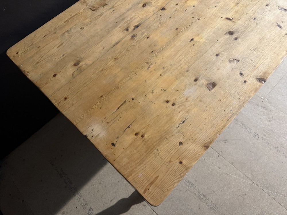 A rectangular pine farmhouse dining table featuring a solid plank top and four turned wooden legs. View VIII