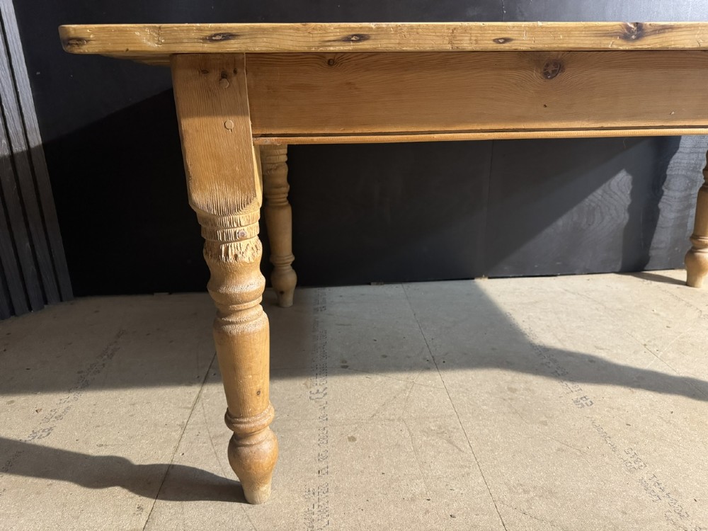 A rectangular pine farmhouse dining table featuring a solid plank top and four turned wooden legs. View IX